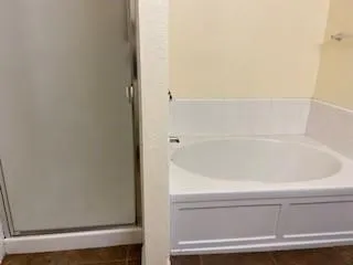 an empty room with wooden floor and closet