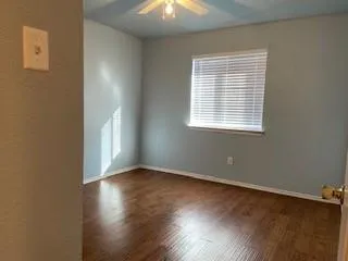 a view of hallway with wooden floor