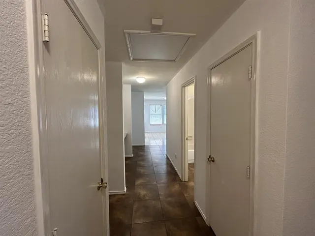 a view of a backyard with grass and wooden fence