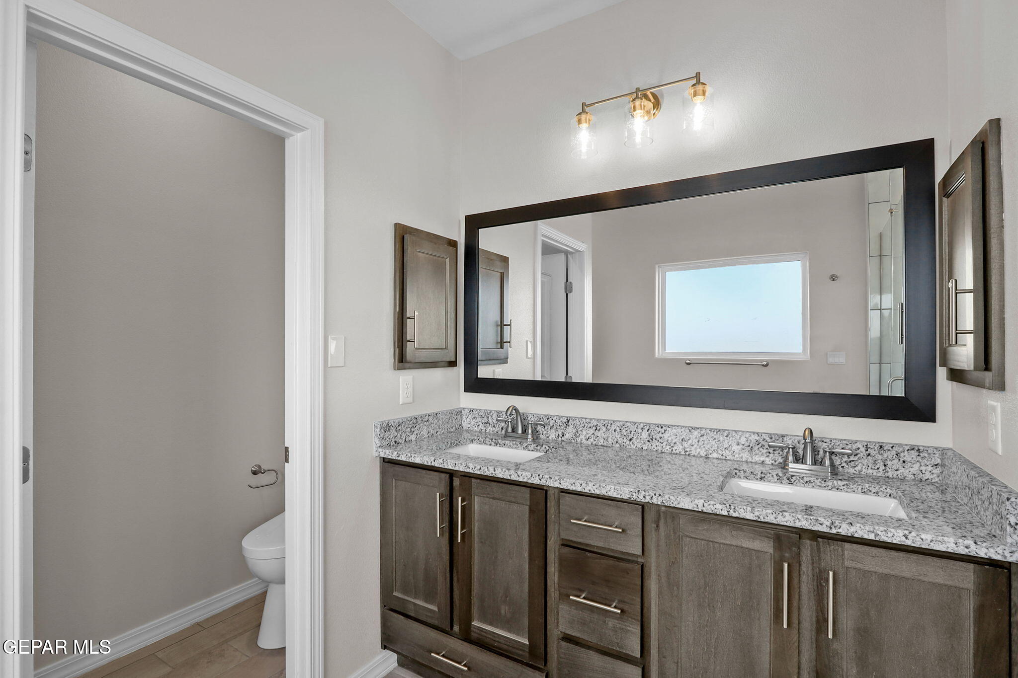 7417 Rio Rimac Drive El Paso, TX 79934 - Photo 38 of 39 a bathroom with a granite countertop sink and a mirror