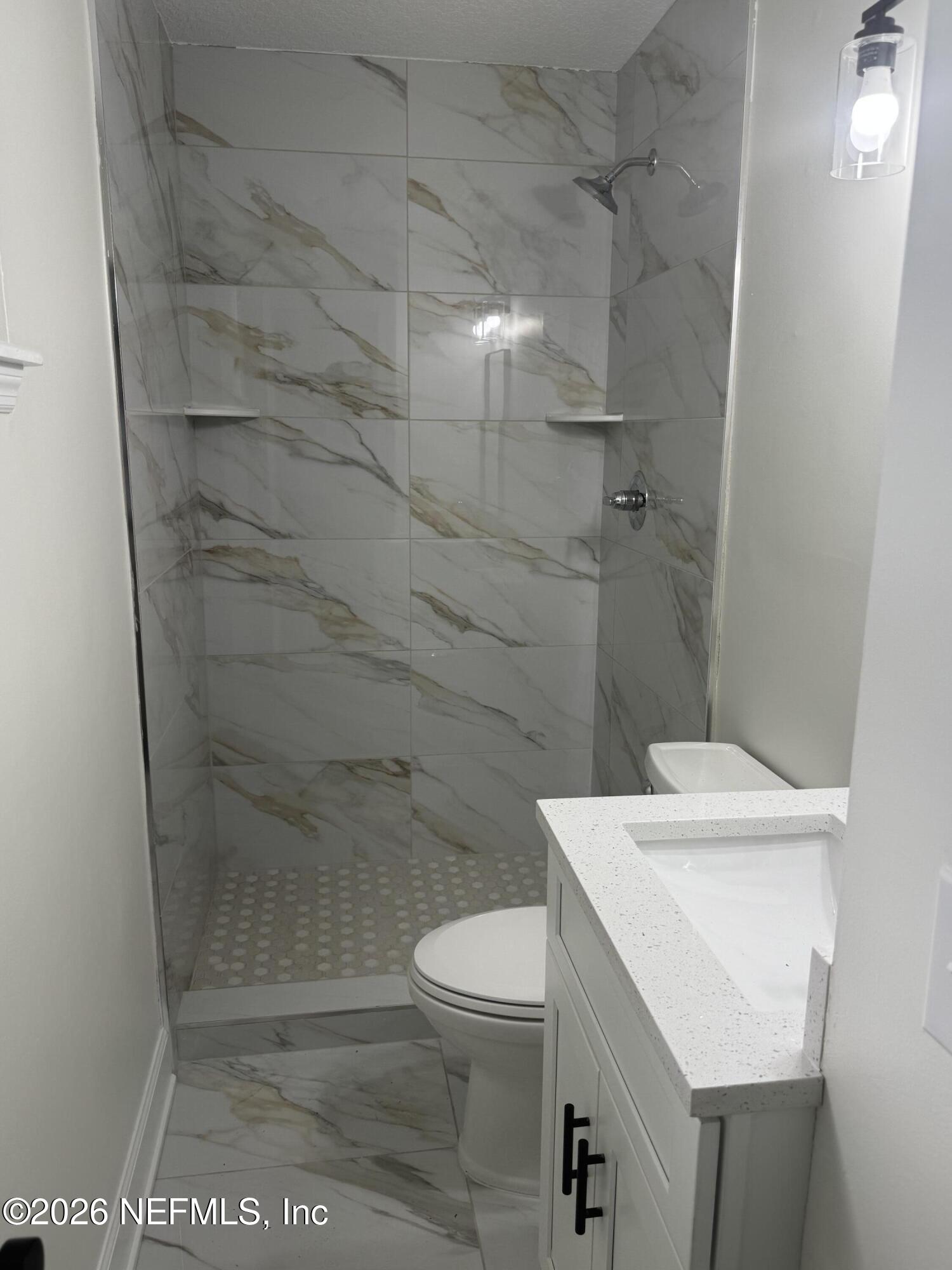 5202 Southwest 155th Street Starke, FL 32091 - Photo 10 of 13 a bathroom with a sink a toilet and shower