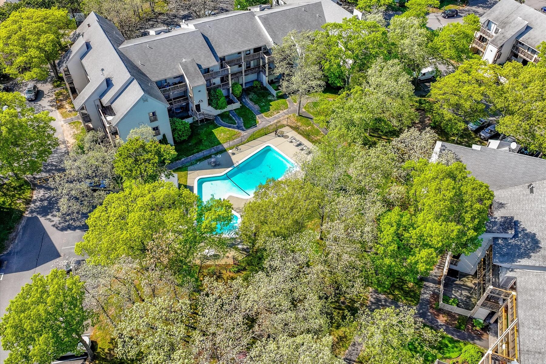 800 Bearses Way, Unit 1EB Hyannis, MA 02601 - Photo 33 of 37 an aerial view of a house with a yard and swimming pool
