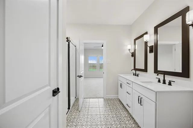 a bathroom with a double vanity sink and mirror