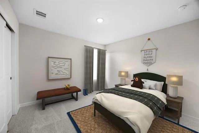 a bedroom with a bed and a couch