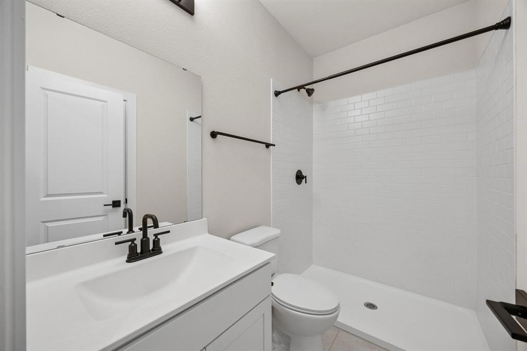1317 Richardson Street Howe, TX 75459 - Photo 19 of 24 a bathroom with a sink toilet and shower