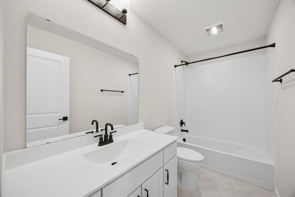 1317 Richardson Street Howe, TX 75459 - Photo 20 of 24 a bathroom with a sink a toilet and shower