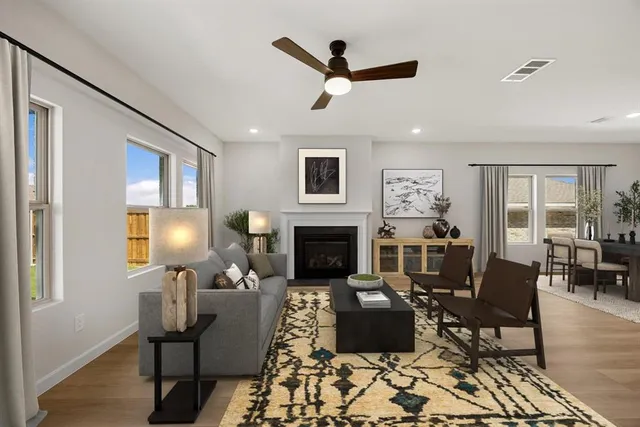 a living room with furniture fireplace and window