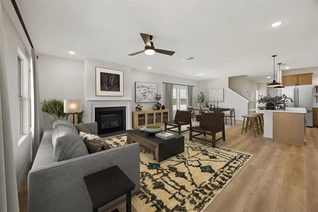 a living room with furniture a fireplace and a flat screen tv