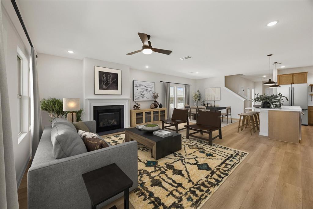 1317 Richardson Street Howe, TX 75459 - Photo 7 of 24 a living room with furniture a fireplace and a flat screen tv