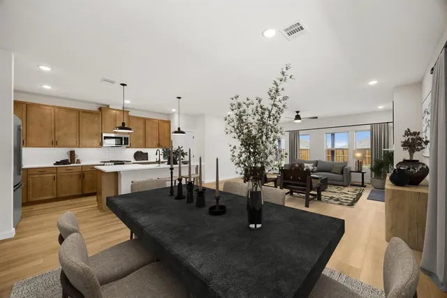 a living room with lots of furniture and kitchen view