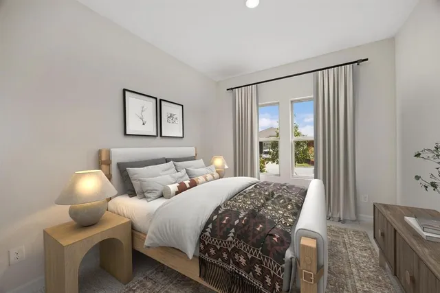 a bedroom with a bed and a large window