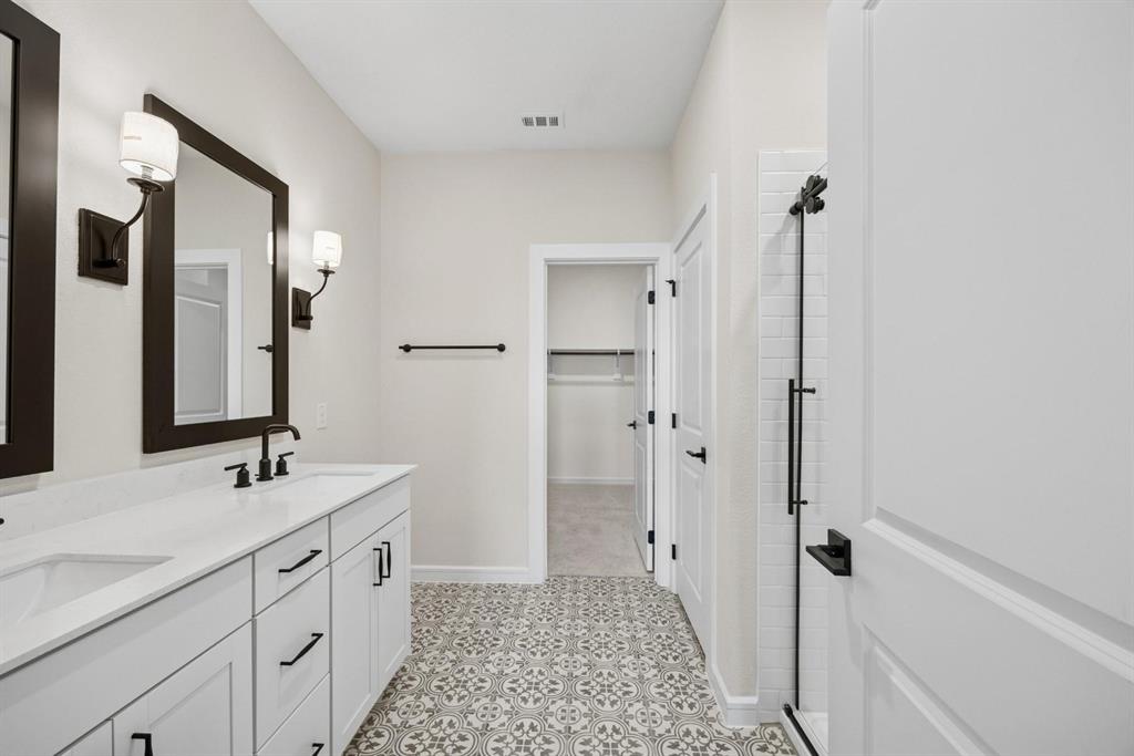 1317 Richardson Street Howe, TX 75459 - Photo 10 of 24 a spacious bathroom with a double vanity sink a mirror and a shower