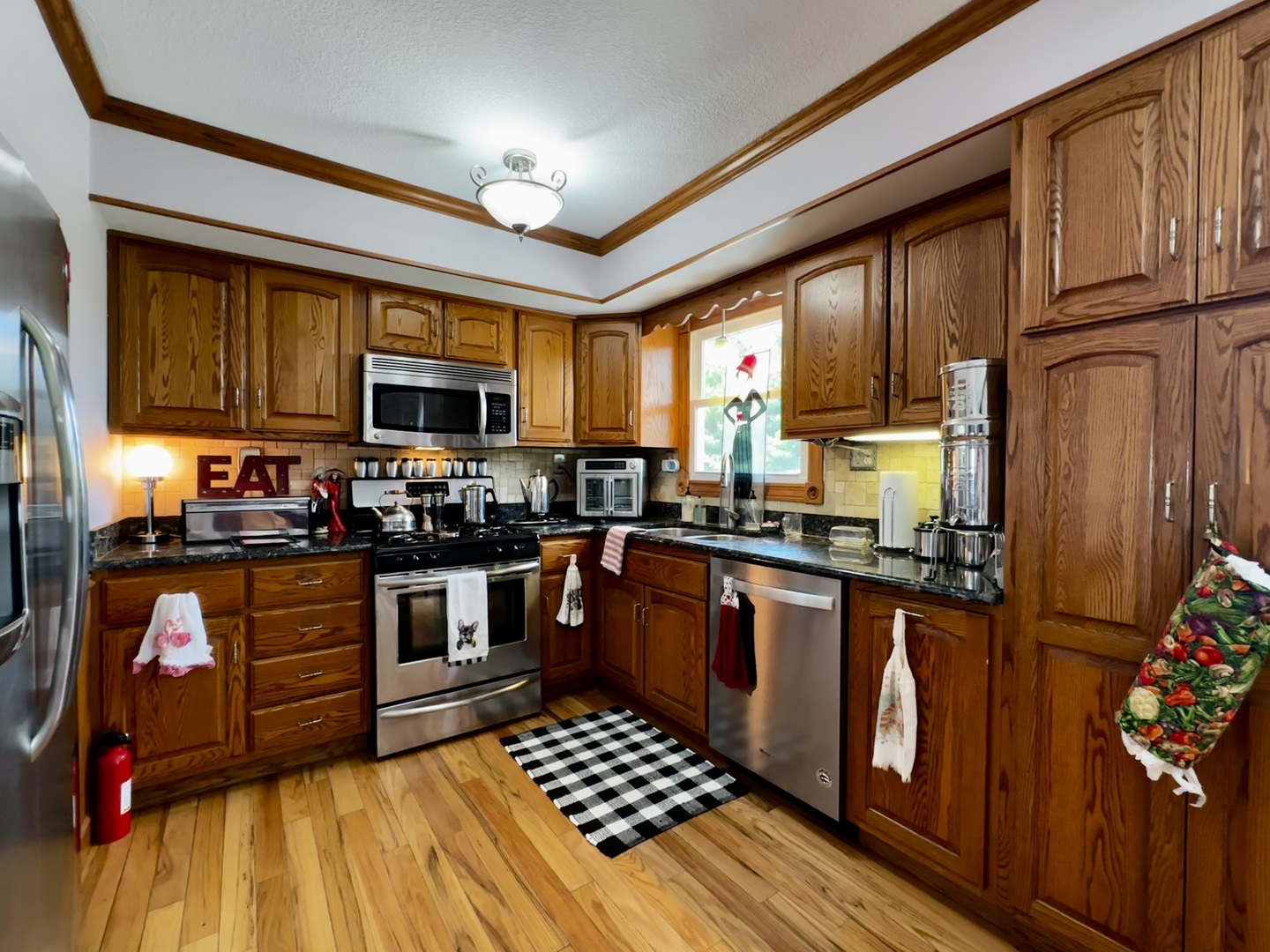 6119 Little Galilee Road Clinton, IL 61727 - Photo 13 of 26 a kitchen with stainless steel appliances granite countertop a stove refrigerator sink and cabinets