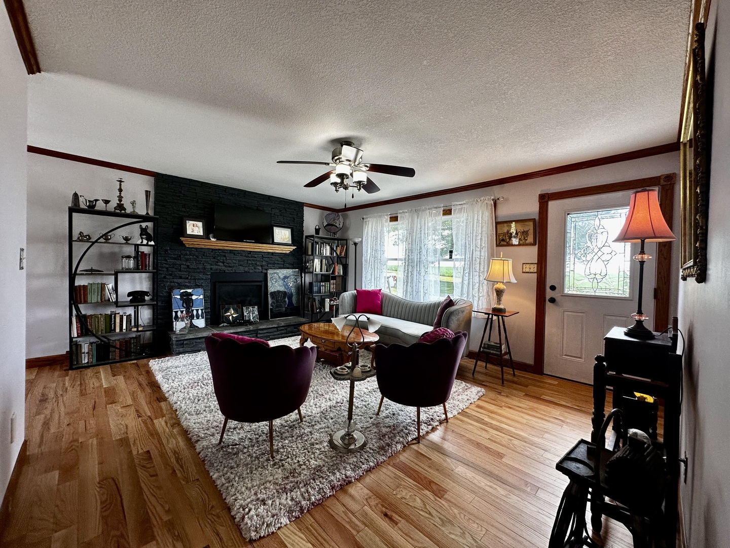 6119 Little Galilee Road Clinton, IL 61727 - Photo 5 of 26 a living room with furniture a fireplace and a flat screen tv
