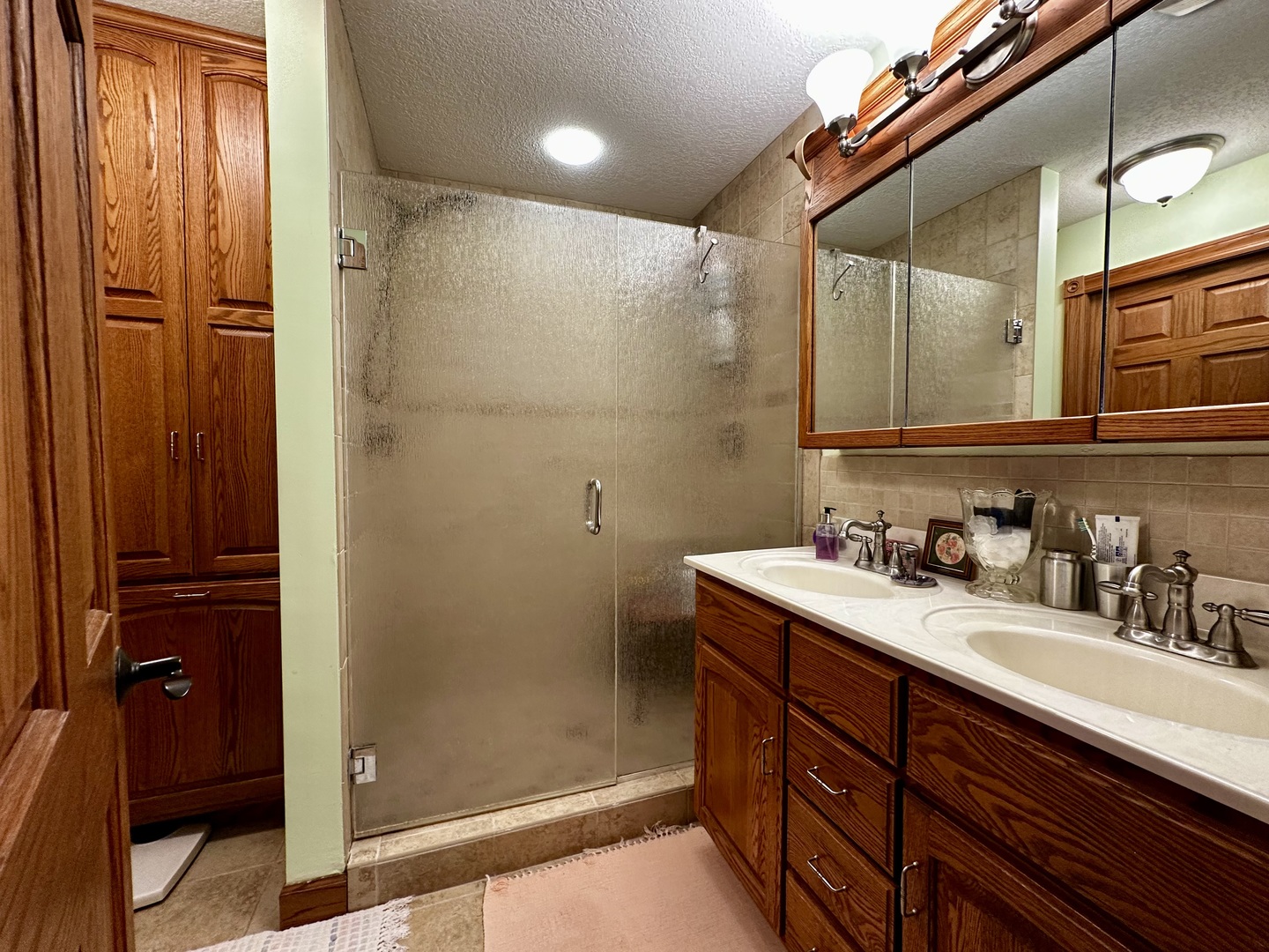 6119 Little Galilee Road Clinton, IL 61727 - Photo 10 of 26 a bathroom with a granite countertop sink a mirror and shower