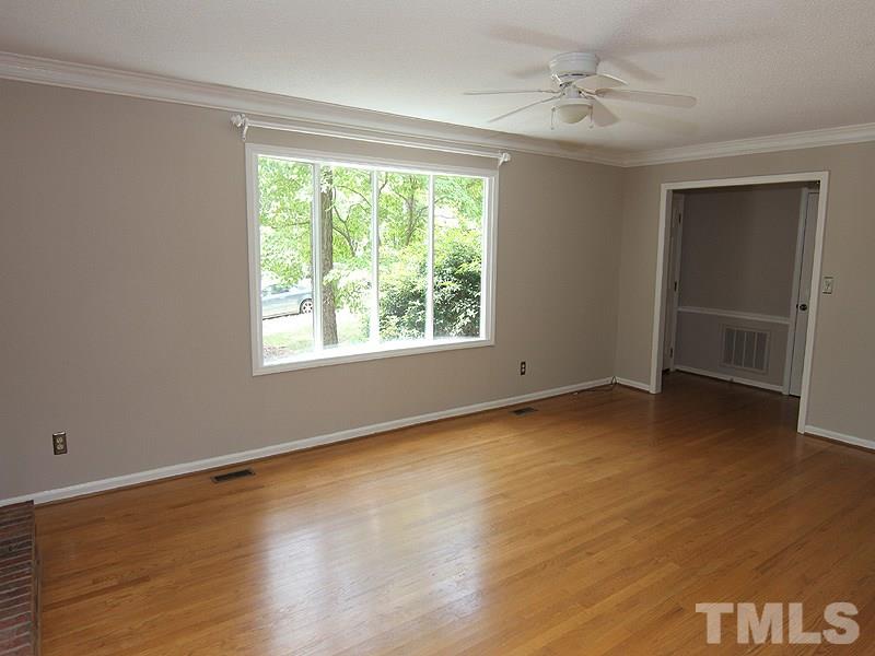 6416 Wynbrook Way Raleigh, NC 27612 - Photo 3 of 13 a view of an empty room with a window and wooden floor