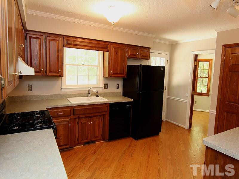 6416 Wynbrook Way Raleigh, NC 27612 - Photo 5 of 13 a kitchen with a refrigerator and a sink