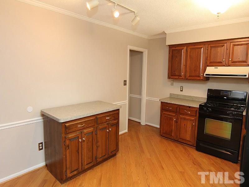 6416 Wynbrook Way Raleigh, NC 27612 - Photo 6 of 13 a kitchen with stainless steel appliances granite countertop a stove a sink and a refrigerator