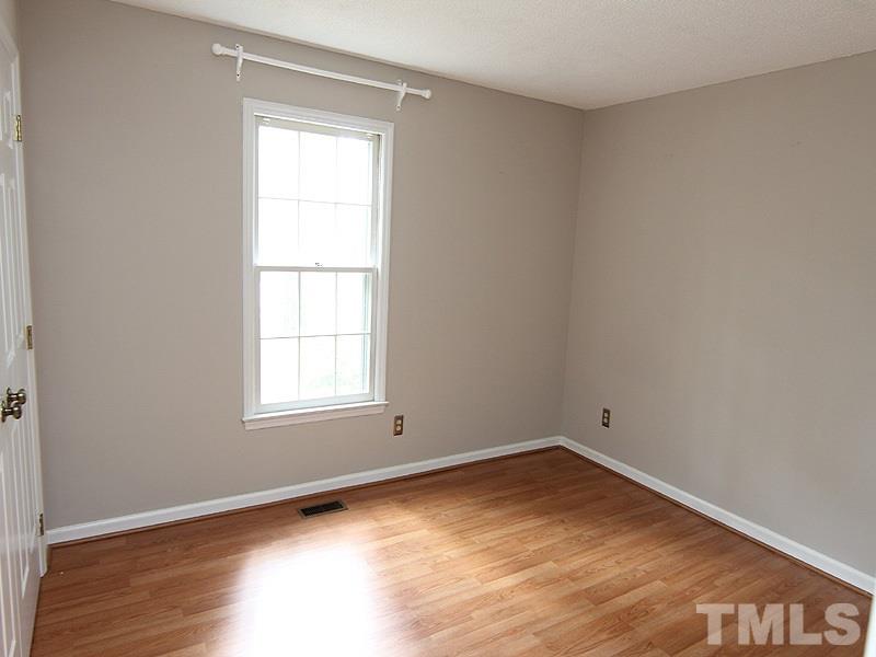 6416 Wynbrook Way Raleigh, NC 27612 - Photo 10 of 13 an empty room with wooden floor and windows