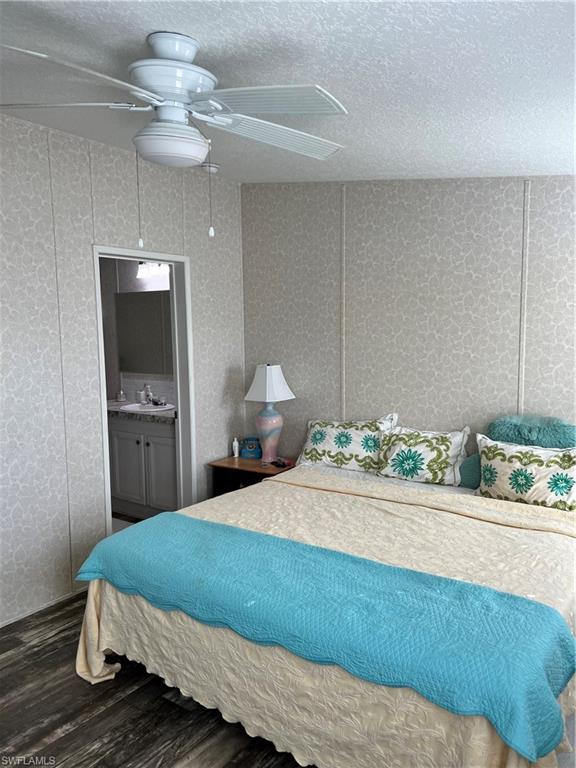 6 Cannes Drive Naples, FL 34112 - Photo 12 of 21 a bedroom with a bed and a chandelier