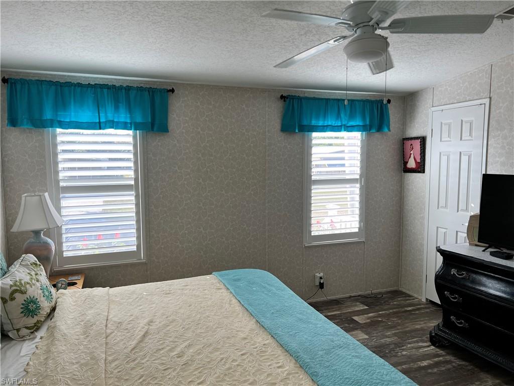 6 Cannes Drive Naples, FL 34112 - Photo 13 of 21 a bedroom with a bed and a flat tv screen on the dresser