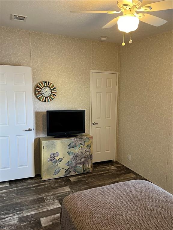 6 Cannes Drive Naples, FL 34112 - Photo 17 of 21 a bedroom with a bed and a flat screen tv