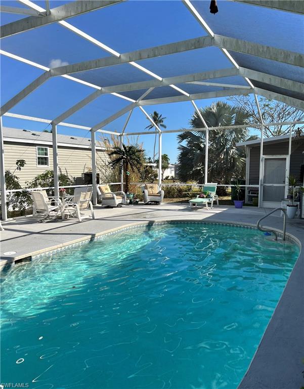 6 Cannes Drive Naples, FL 34112 - Photo 20 of 21 a patio with table and chairs under an umbrella