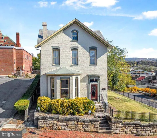 a front view of a house with lots of yellow lighting