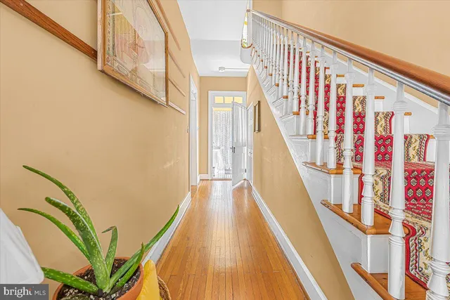 a view of entryway with wooden floor and stairs
