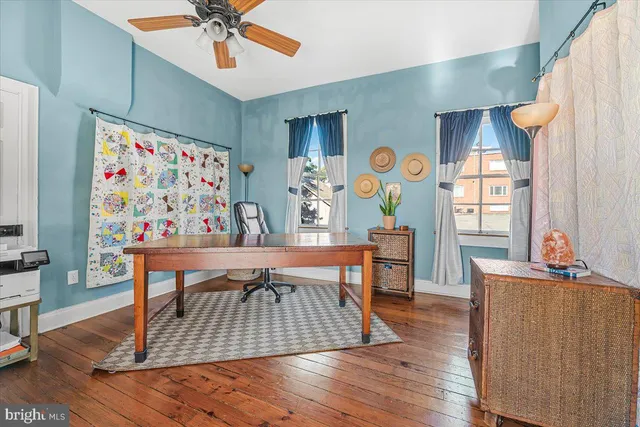 a view of a livingroom with furniture window and wooden floor