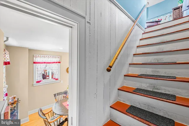 a view of entryway with stairs and a chandelier