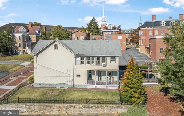 a view of a white building among the street and a building