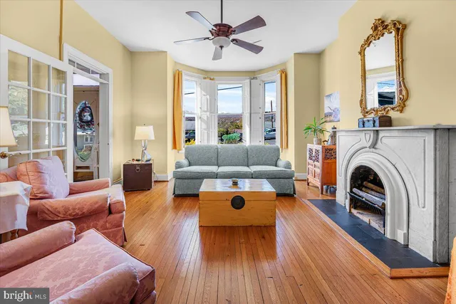 a living room with furniture fireplace and large windows