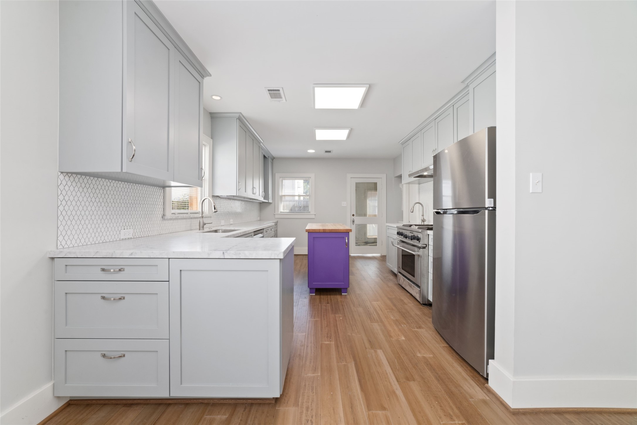 2907 Albany Street Houston, TX 77006 - Photo 15 of 29 a kitchen with a refrigerator sink and cabinets