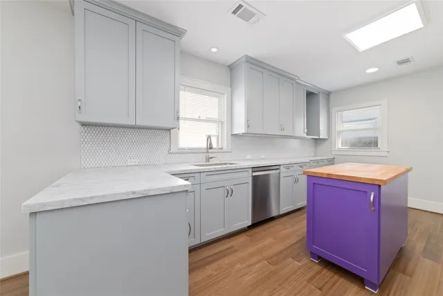 a kitchen with a stove a refrigerator and a sink