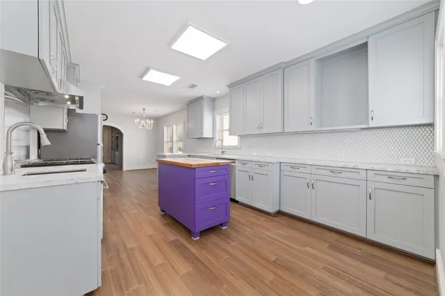 a kitchen with a stove window and cabinets
