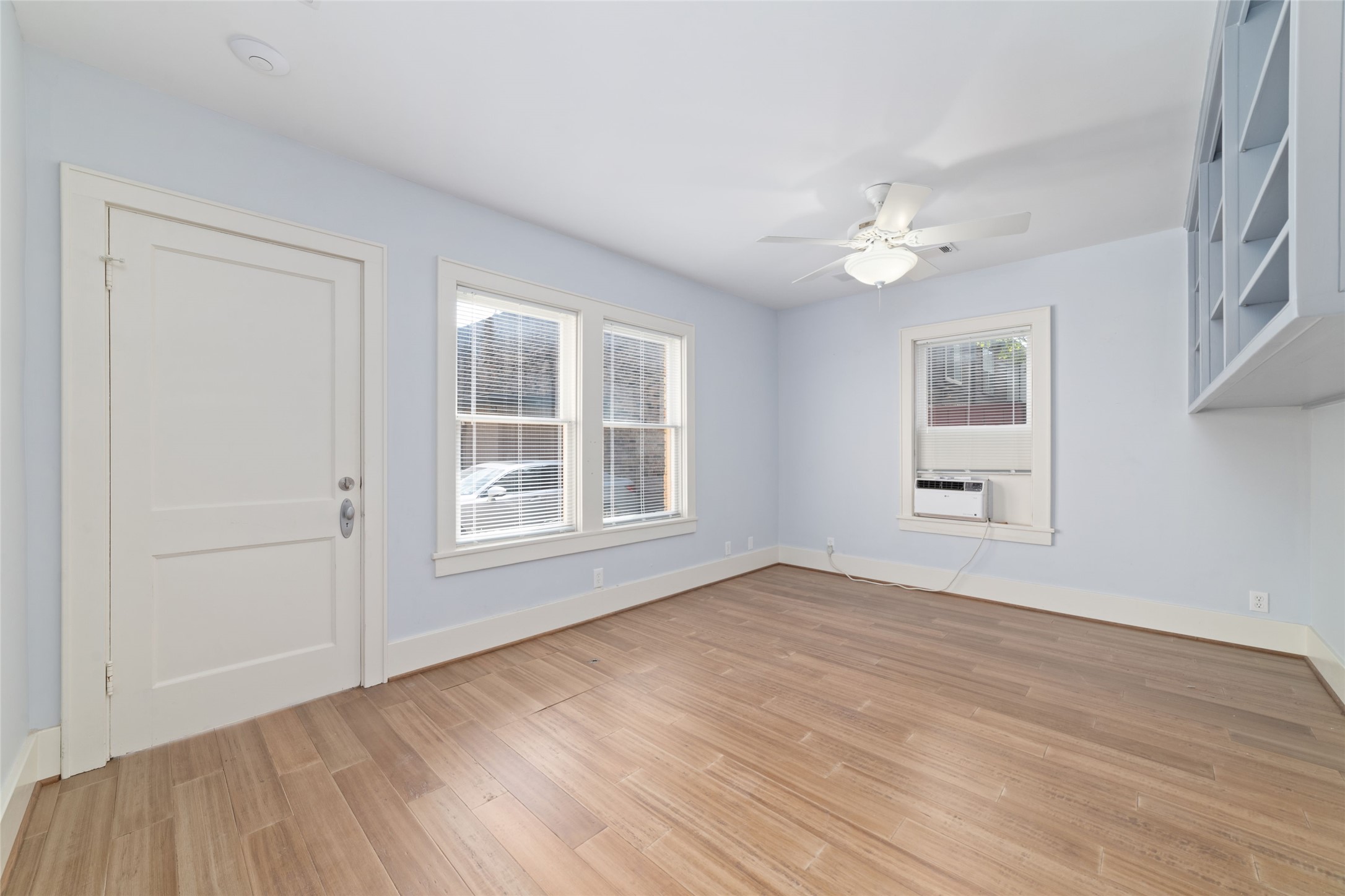 2907 Albany Street Houston, TX 77006 - Photo 24 of 29 a view of an empty room with a window and wooden floor