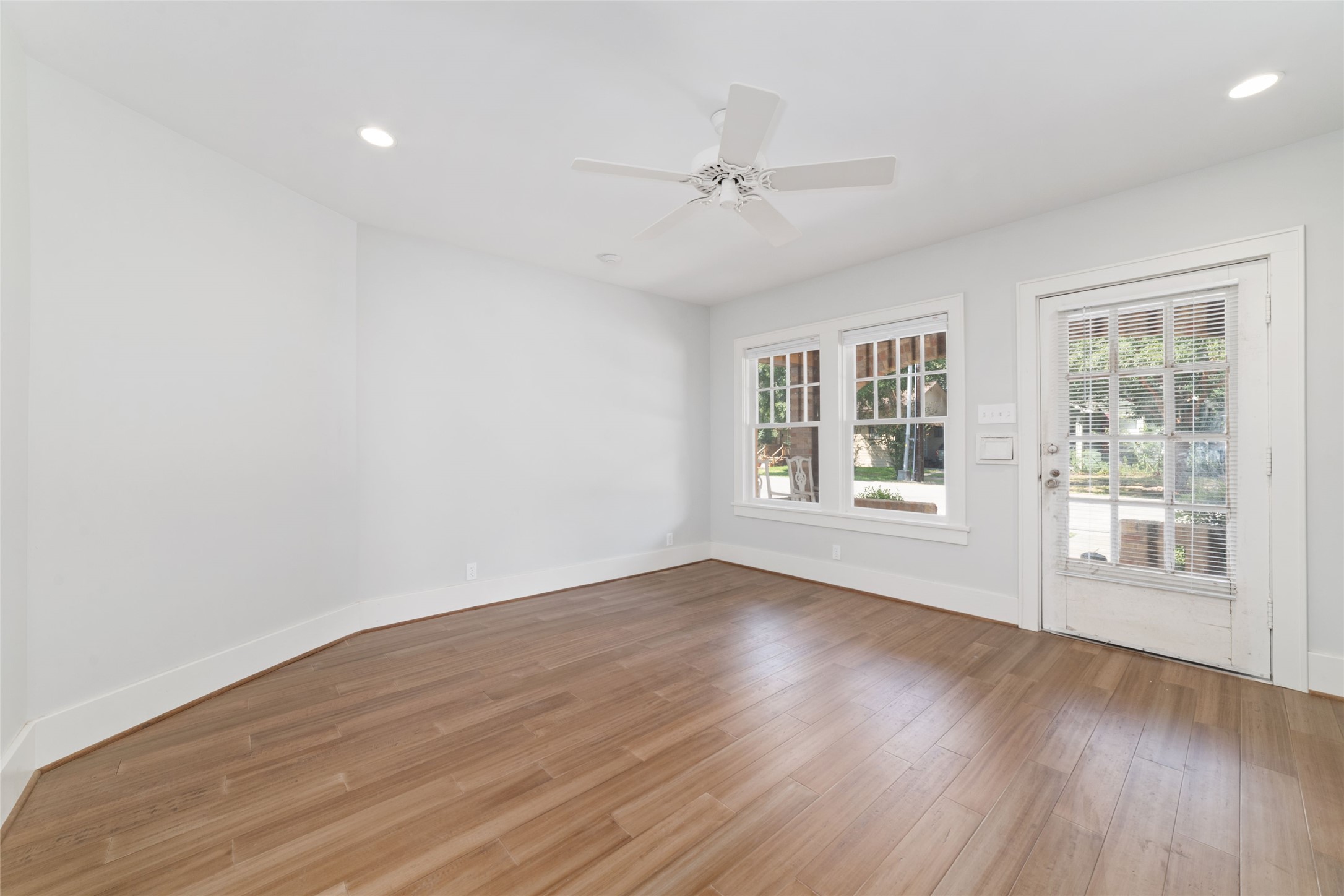 2907 Albany Street Houston, TX 77006 - Photo 4 of 29 a view of an empty room with wooden floor and a window