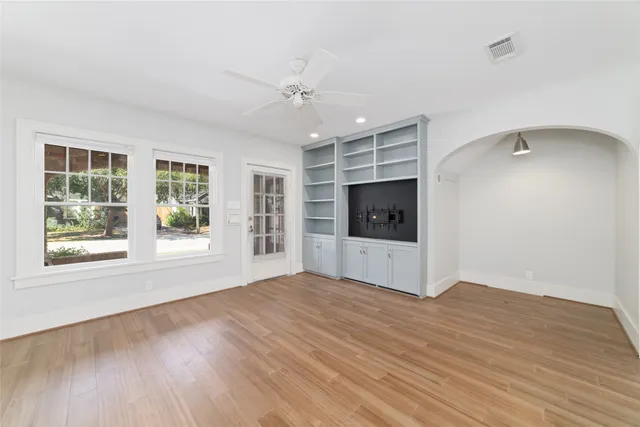 a living room with furniture kitchen view and a window