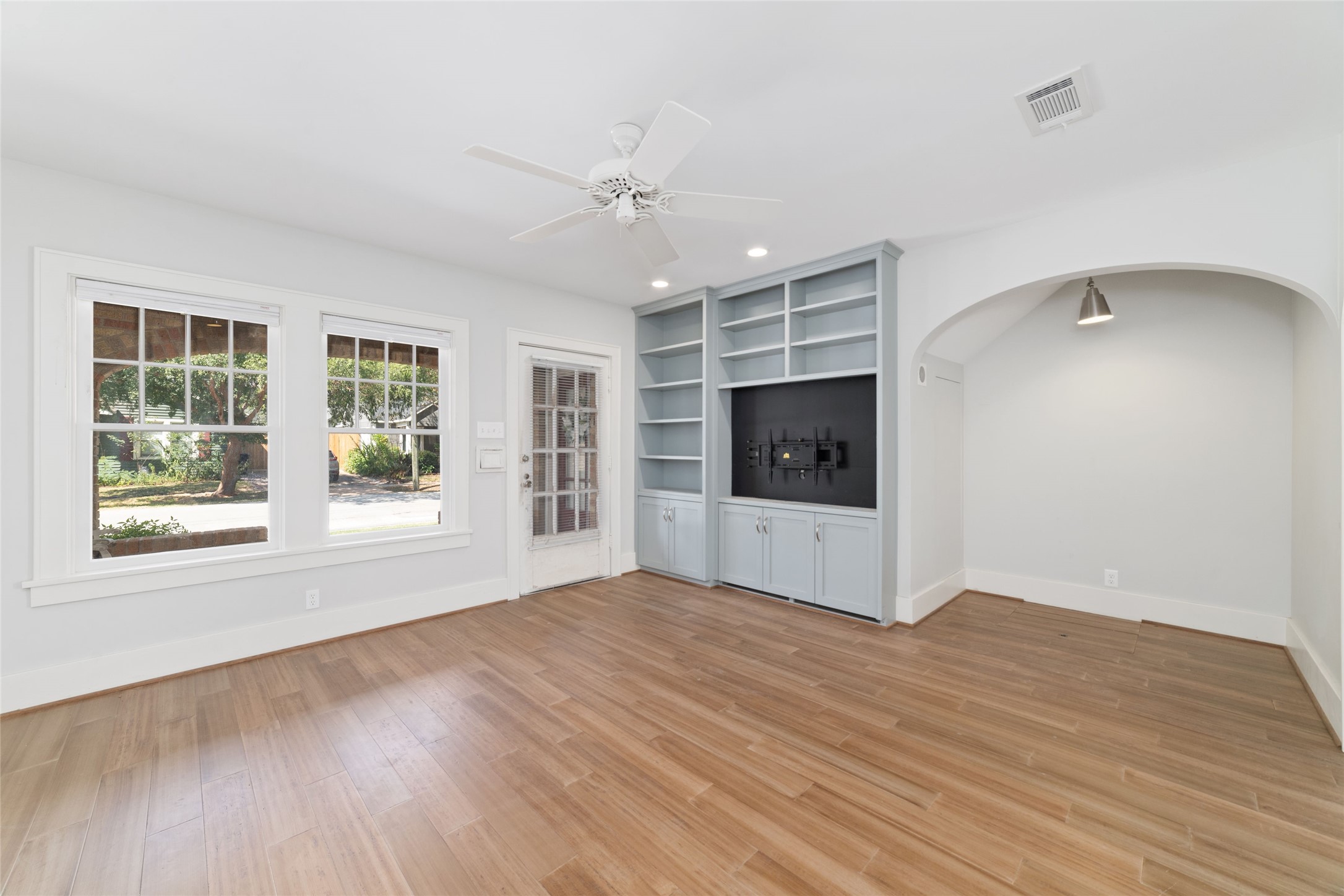 2907 Albany Street Houston, TX 77006 - Photo 5 of 29 a view of an empty room with a window and wooden floor