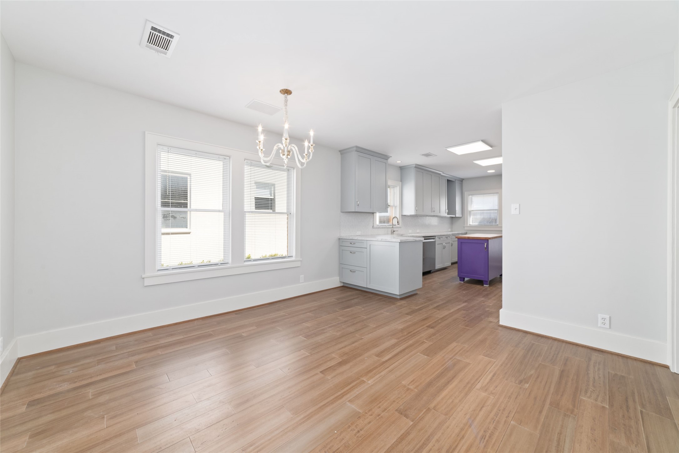 2907 Albany Street Houston, TX 77006 - Photo 7 of 29 a view of a kitchen with a sink cabinets and wooden floor