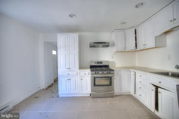 a kitchen with cabinets appliances and a sink