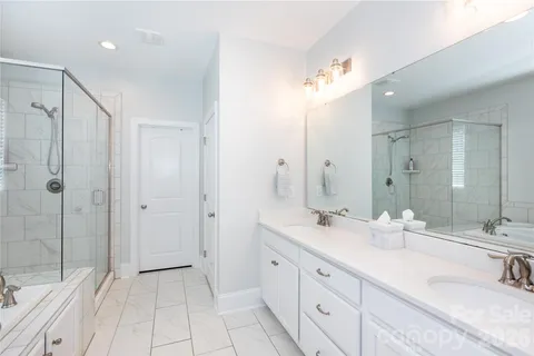 a bathroom with a double vanity sink mirror and double