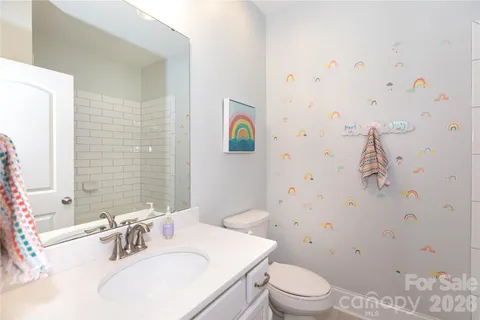 a bathroom with a sink a toilet and shower curtain
