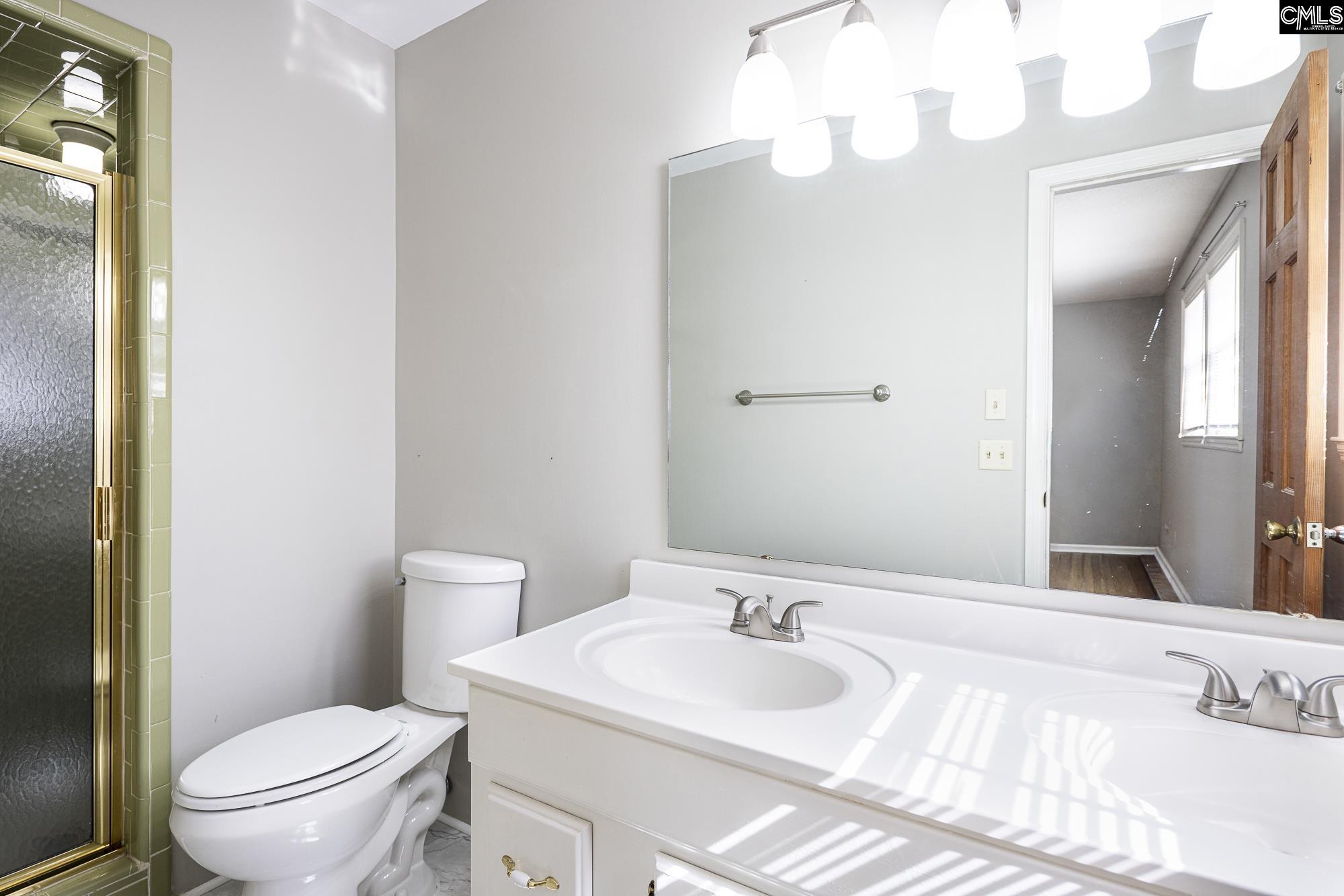 4083 Platt Springs Road West Columbia, SC 29170 - Photo 23 of 35 a bathroom with a sink vanity mirror and toilet