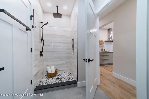 a bathroom with a glass shower door and a sink