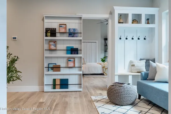 a living room with furniture and a book shelf