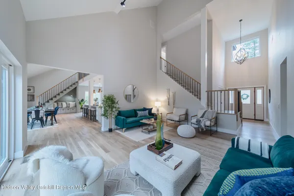 a living room with furniture potted plant and a chandelier