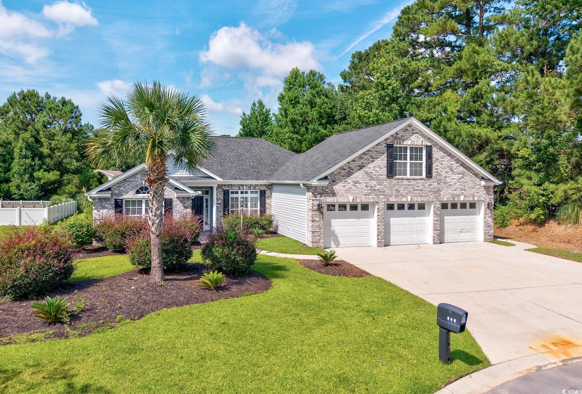 Traditional-style house with driveway, brick sidin
