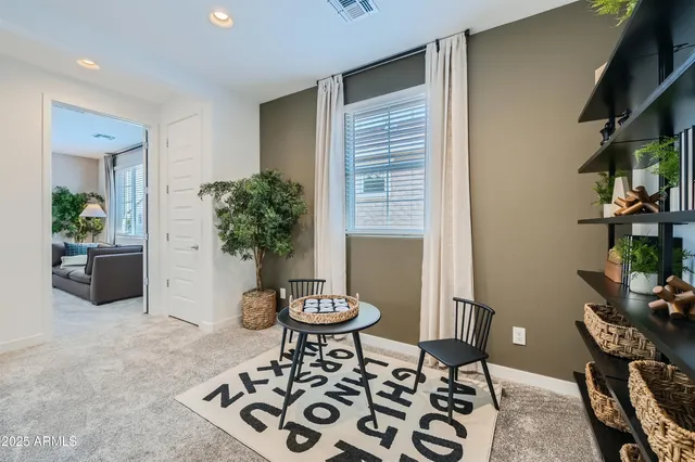a view of a workspace room with furniture